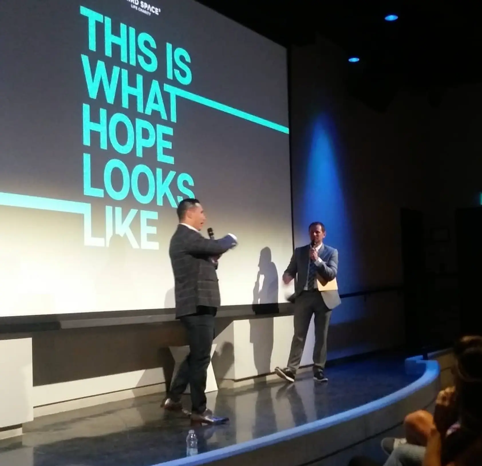 Speakers on stage at a charity screening
